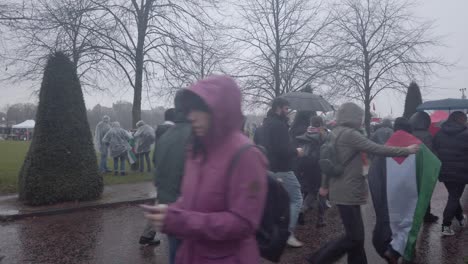 A-group-of-people-walking-past-young-people-raising-money-for-Gaza