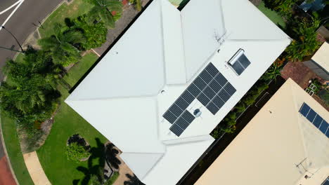 Aerial-Drone-of-Tropical-Home-Roof-with-Palm-Trees-on-Corner-of-Traffic-Circle-With-Pool-Area,-Top-Down-Ascend-Rotate