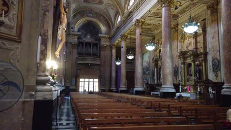 Empty-benches-wooden-for-worship-christian-church-basilica-san-jose-de-flores-at-buenos-aires-city-argentina-golden-roof-eclectic-architecture-balconies-and-columns