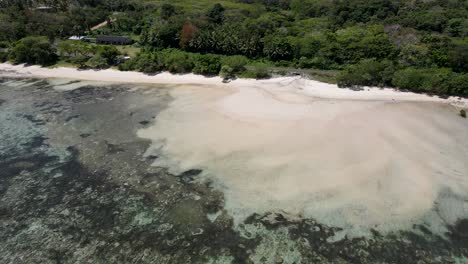 Imágenes-Aéreas-Tomadas-Con-Drones-De-La-Costa-De-Coral-De-Viti-Levu-Revelan-Impresionantes-Arrecifes-De-Coral,-Aguas-Turquesas,-Exuberante-Vegetación-Y-Playas-Solitarias,-Lo-Que-Permite-Vislumbrar-La-Belleza-Natural-De-Fiji-Desde-Arriba.