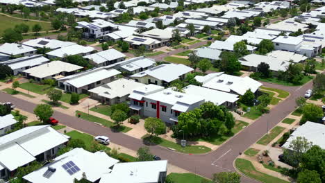 Aerial-Drone-of-Busy-Traffic-In-Residential-White-Townhouse-Estate-of-Muirhead-Darwin-NT-Australia,-Orbit