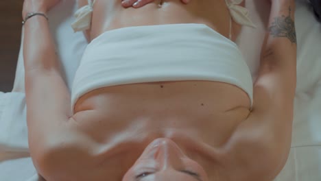 Slow-revealing-shot-of-a-woman-receiving-a-relaxing-massage-in-a-bikini