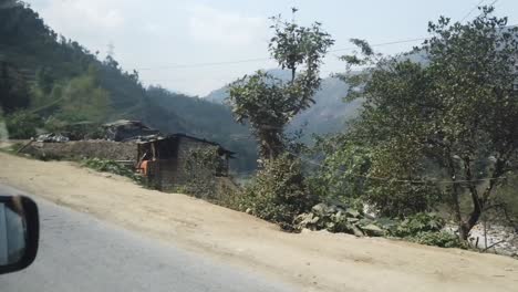 We-passed-little-shops-and-these-homes-that-looked-like-they-could-fall-over-along-the-road-on-our-way-to-Pokhara-from-Kathmandu