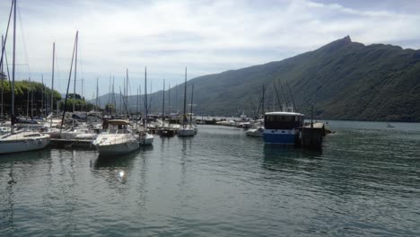 Motorboats-docked-at-Aix-Les-Bains-France-Time-Lapse-Dent-du-Chat-mountain-background,-calm-water-scenario,-Lake-Bourget-in-the-Savoie,-eastern-France
