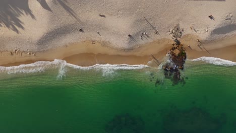 Chahue-Beach-in-Huatulco,-Oaxaca,-where-golden-sands-blend-seamlessly-with-emerald-hues-of-the-sea