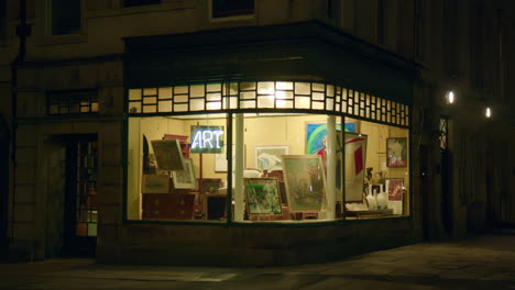 Shop-With-Paintings-In-The-Evening-In-Bath,-England---Wide-Shot