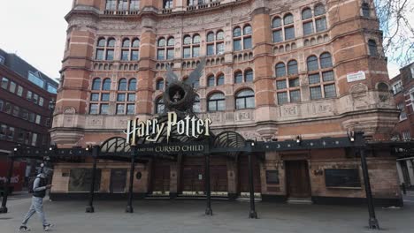 Person-Walking-Past-Palace-Theatre-on-Shaftesbury-Avenue-In-The-Morning