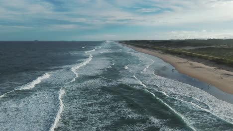 Bird's-eye-view-of-a-magnificent-beach-on-the-Atlantic-Ocean,-stretching-endlessly
