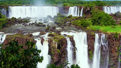 Timelapse-of-Waterfalls-of-Iguazu-around-a-big-green-area,-in-a-sunny-day,-Foz-do-Iguacu,-Parana,-Brazil