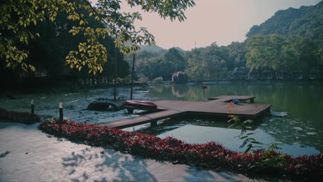 Tranquil-lakeside-pier-with-boats-and-foliage