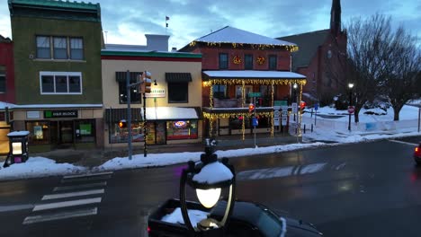 Rising-drone-shot-of-traffic-on-snowy-street-in-winter