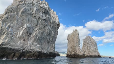 The-back-side-of-the-famous-Arch-of-Cabo-San-Lucas---panning-sea-level-POV