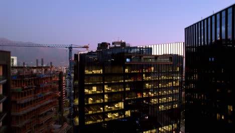 Aerial-view-rising-in-front-of-the-Mercado-Urbano-Tobalaba,-dusk-in-Santiago-de-Chile