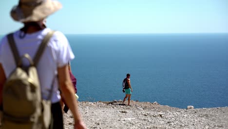 people-walking-near-a-cliff-and-watch-the-amazing-sea-view,-traveler-lifestyle