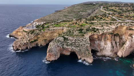 Blue-Grotto-In-Malta,-Aerial-View-From-The-Mediterranean-Sea-To-The-Island