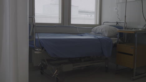 Zoom-in-static-shot-of-unoccupied-bed-in-hospital