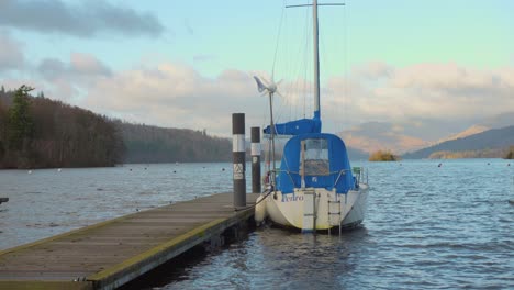 A-sailboat-is-moored-at-a-dock-on-Lake-Windemere