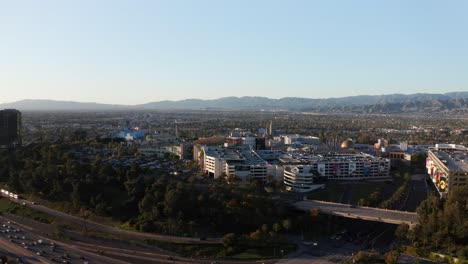 Aerial-wide-panning-shot-of-Universal-Studios-Hollywood-during-sunset-in-Los-Angeles,-California