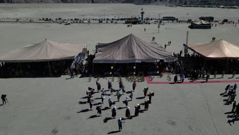 Backward-drone-view-of-Sarfaranga-Jeep-Rally-event-at-Skardu,-Pakistan