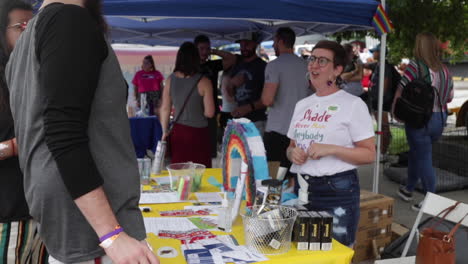 People-visit-the-City-of-Columbia-Health-Department's-booth-during-MidMo-PrideFest-in-Columbia,-MO