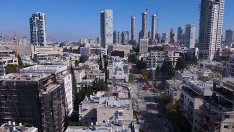 David-Bloch-Street-in-Tel-Aviv-Israel,-aerial-pullback-ascend-above-construction