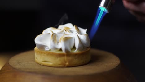 Close-up-clip-of-chef-using-blowtorch-to-brown-the-top-of-meringue-on-lemon-tart