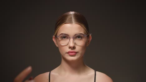 Smart-young-female-student-adjusts-her-glasses,-concept-thinking,-gets-an-idea