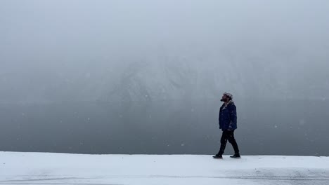 Side-profile-view-of-a-person-walking-in-snow-in-Skardu-city,-Pakistan