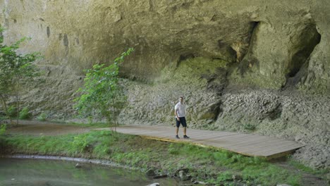 Local-tourist-is-walking-on-a-wooden-ramp-Gods-Bridge,-near-Vratsa