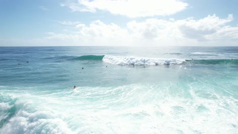 Surfers-Riding-The-Ocean-Waves-In-Cabarita-Beach,-New-South-Wales,-Australia---Drone-Shot