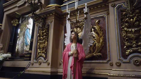 Artwork-statue-of-guardian-angel-with-wings-virgin-mary-praying-on-her-knees-flowers-decoration-at-basilica-san-jose-de-flores-inside-buenos-aires-argentina-religious-christian-travel-spot