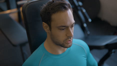 Man-in-Gym-Face-Close-up-Focuses-On-His-Breathing-After-Intense-Exercise