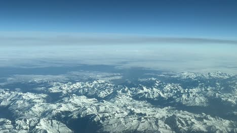 Aerial-view-of-snowed-Pyrenees-Mountains-crossing-from-Spain-to-France-at-10000m-high