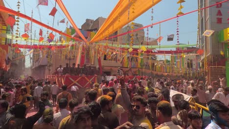 pov-shot-but-all-men-are-enjoying-dhuleti-and-flying-colors-where-men-are-going-towards-the-temple