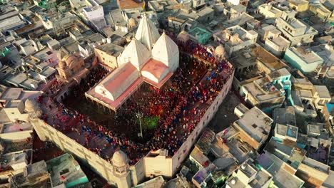 people-playing-lath-mar-Holi-repeatedly-and-above-there-are-many-colorful-drums-for-people-playing-Holi-and-people-are-coloring