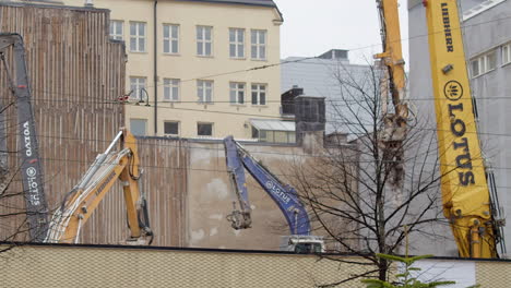 Schwere-Bagger-Arbeiten-Hinter-Einer-Mauer-Auf-Einer-Städtischen-Baustelle