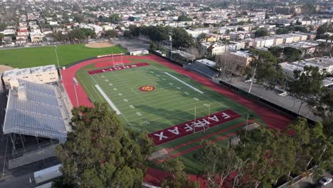 Aerial-view-of-a-high-school-football-field-and-adjoining-neighborhood