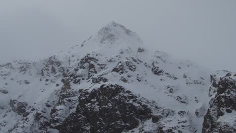 Italian-mountain,-peak-soaring-into-sky,-adorned-with-pristine-snow-blanket