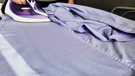 Man-Ironing-Blue-Striped-Shirt---Slow-Motion-Video