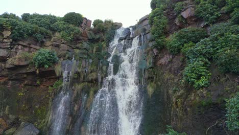 Aerial-drone-footage-of-a-tall-rocky-waterfall-in-the-Yorkshire-Dales,-Pennies