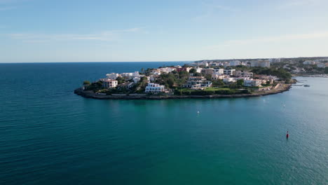 Luxury-Real-estates-at-Tranquil-Porto-Colom-bay,-Mallorca,-with-clear-blue-waters