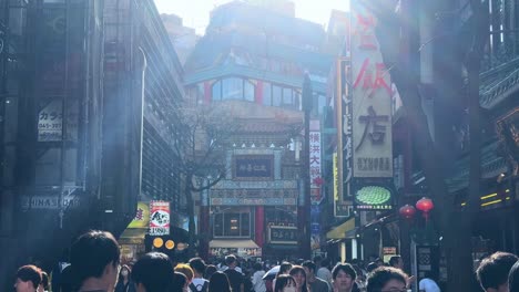 Japanese-people-walk-at-bustling-daylight-market-outdoors-urban-streets-downtown-at-Yokohama-Japan