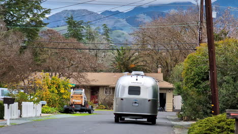 Vintage-America-mobile-home-being-towed-in-small-town,-California