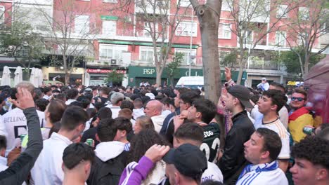 Panning-shot-of-fans-cheer-and-gather-at-Real-Madrid´s-Santiago-Bernabeu-stadium-as-they-attend-the-Champions-League-football-match-between-Spanish-and-British-teams-Real-Madrid-and-Manchester-City