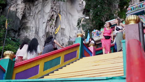 Tourists-Climbing-Colorful-Steps-At-Batu-Caves-In-Kuala-Lumpur,-Malaysia