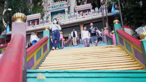 Tourists-Climbing-On-Colorful-Steps-On-Batu-Caves-In-Gombak,-Selangor,-Malaysia