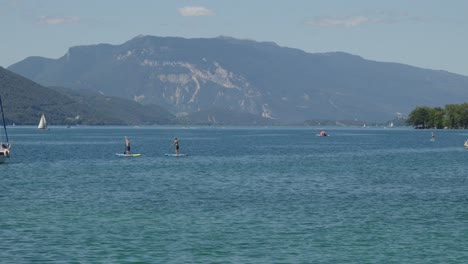Time-lapse-tourists-paddling-at-Lake-Bourget-waters-kayak-calm-natural-mountain-hills-environment-at-Spa-Town,-Aix-Les-Bains-France
