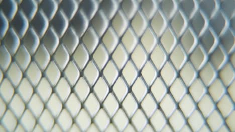 A-hyper-macro-shot-of-a-metal-grid,-steel-pattern,-iron-industrial-texture,-aluminum-material,-super-slow-motion,-Full-HD-120-fps,-tilt-up-smooth-movement,-blurry-DOF