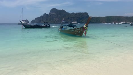 Long-tail-boats-standing-on-shores-of-Phi-Phi-islands-beach-paradise