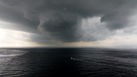 Speeding-boat-travels-across-ocean-water-surface,-escape-oncoming-storm